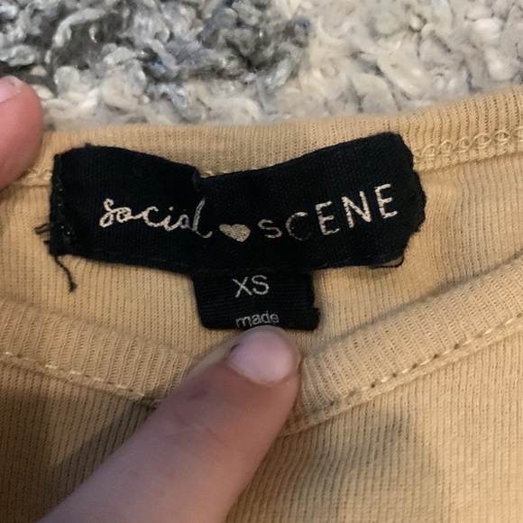 Tan colored shirt that has a flower on it - Picture 3 of 3